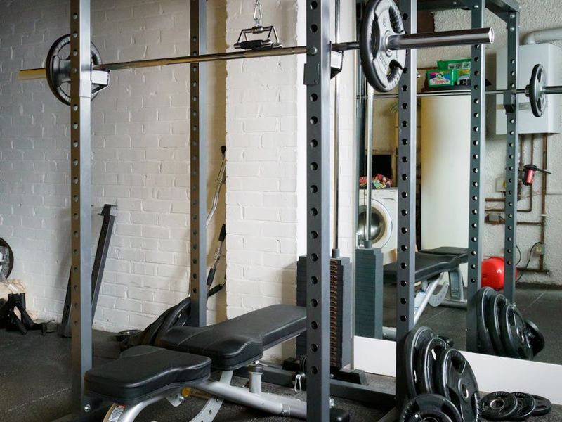 Professional gym racks with heavy barbells and weight plates