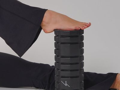 Stretching mat and foam roller on a wooden floor