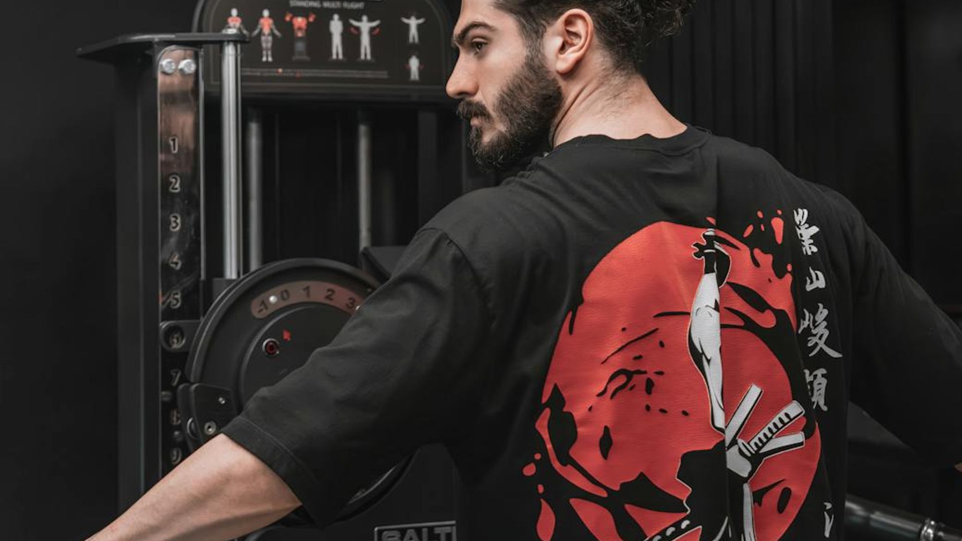 Strong man focusing on his workout routine in a dark modern gym